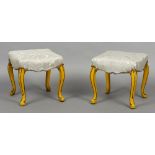 A pair of 19th century upholstered painted stools Each overstuffed seat standing on scroll carved