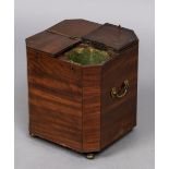 A 19th century mahogany cellaret Of chamfered square form with four hinged compartment lids,