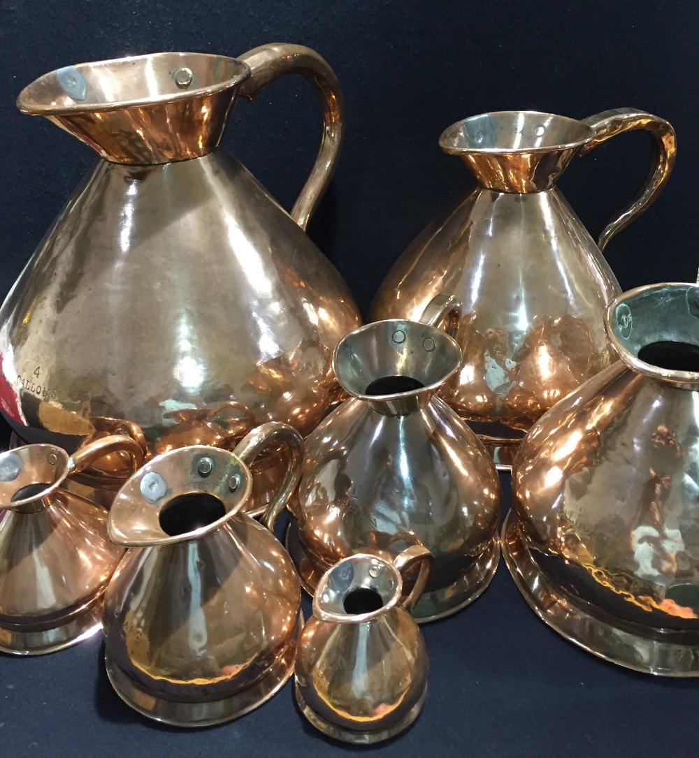 A 19th century matched graduated set of seven copper haystack measures The largest 4 gallons.