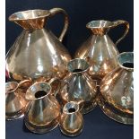 A 19th century matched graduated set of seven copper haystack measures The largest 4 gallons.