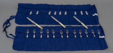 A set of twelve mother-of-pearl handled silver knives and forks, possibly marked for London 1815,