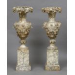 A pair of 19th century alabaster pedestal urns Each with fruiting vine and acanthus decorations,