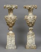 A pair of 19th century alabaster pedestal urns Each with fruiting vine and acanthus decorations,