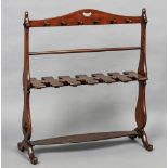 A 19th century mahogany whip and boot rack Of typical shaped trestle form,