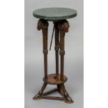 A 19th century Continental marble topped torchere The circular green marble top above three carved