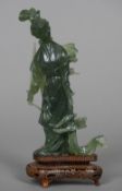 A Chinese carved jade figure Guanyin Typically modelled holding a sword,