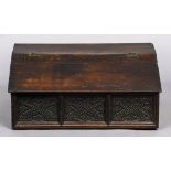 A 17th/18th century carved oak slope topped Bible box The hinged top with sloping front above three