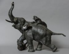 A large Japanese Meiji period bronze animalier group Formed as two tigers attacking an elephant,