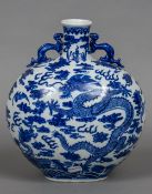 A Chinese blue and white porcelain twin handled vase Decorated with five clawed dragons amongst