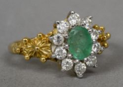 An 18 ct gold diamond and emerald cluster ring Of flowerhead form.