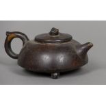 A 19th century Japanese patinated bronze teapot Of squat form, with a loop handle,