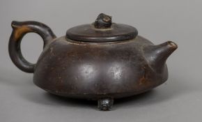 A 19th century Japanese patinated bronze teapot Of squat form, with a loop handle,