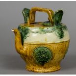A Chinese pottery wine ewer With an angular loop handle above a band of lappet decoration,