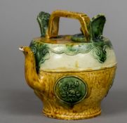 A Chinese pottery wine ewer With an angular loop handle above a band of lappet decoration,