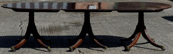 A 19th century mahogany triple pillar dining table The moulded rounded top above three pedestals