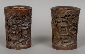 A pair of Chinese carved bamboo brush pots Each worked with figures in a mountainous forest