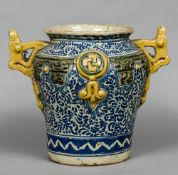 An antique maiolica drug jar With twin pierced handles, on a blue and white ground. 32.5 cm high.