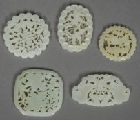 Five various Chinese pierced and carved jade pendants The largest 6.5 cm wide.