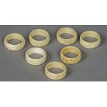 A set of seven late 19th/early 20th century Canton carved ivory napkin rings Each decorated in the