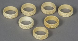 A set of seven late 19th/early 20th century Canton carved ivory napkin rings Each decorated in the