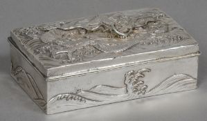 A Japanese silver box The rectangular hinged cover worked with a dragon,