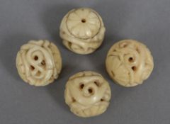 Four 19th century carved marine ivory balls Each approximately 2 cm diameter.