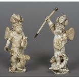 A pair of 18th/19th century Dieppe carved ivory figures Each formed as a cherub fighting a dragon.