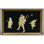 A framed plaque set with three 19th century Japanese carved figures Centred with a gentleman with a