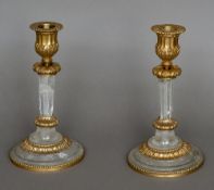 A pair of rock crystal candlesticks Each with gilt bronze, floral and lappet cast mounts.