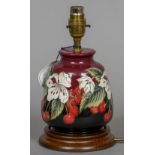 A modern Moorcroft pottery table lamp With red ground and cherry decoration. 24 cm high.