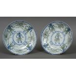 A pair of unusual Japanese porcelain dishes Each decorated with stylised figures and various