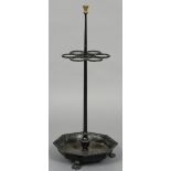 A cast iron sticks stand Of free standing form with six stick apertures above the octagonal tray