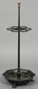 A cast iron sticks stand Of free standing form with six stick apertures above the octagonal tray