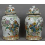 A pair of large Chinese porcelain vases and covers Each with a white ground decorated in the round