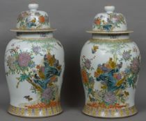 A pair of large Chinese porcelain vases and covers Each with a white ground decorated in the round