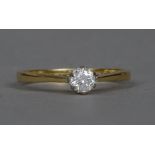 An 18 ct gold diamond solitaire ring The claw set stone approximately 0.25 carat.