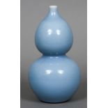 A Chinese blue ground double gourd vase The underside with blue painted seal mark. 24.5 cm high.
