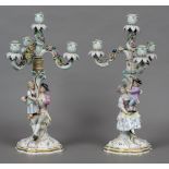 A pair of 19th century Meissen porcelain candelabra Each of twin figural form with three floral