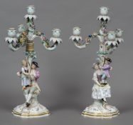 A pair of 19th century Meissen porcelain candelabra Each of twin figural form with three floral