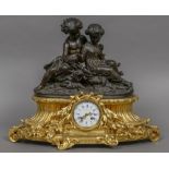 A 19th century French patinated and gilt bronze mantel clock Surmounted with two young children,