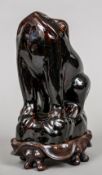 A 19th century Chinese porcelain model of a frog With an allover treacle brown glaze,