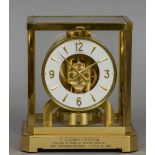 An brass cased LeCoultre Atmos clock Of typical form, the base with a presentation inscription. 23.