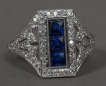 A diamond and sapphire set white metal ring The sapphires rectangular set.