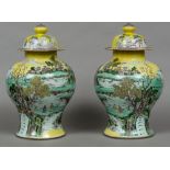 A pair of 19th century Chinese yellow ground vases and covers Each of waisted ovoid form,