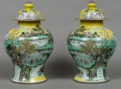 A pair of 19th century Chinese yellow ground vases and covers Each of waisted ovoid form,