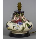 A modern Moorcroft pottery table lamp Of squat form, with typical floral decoration. 24 cm high.