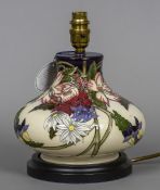 A modern Moorcroft pottery table lamp Of squat form, with typical floral decoration. 24 cm high.