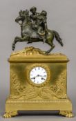 A 19th century French Empire bronze mounted ormolu cased mantel clock The white enamelled dial with