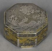 A late 19th century Japanese unmarked white and gilt metal box Of hinged octagonal form,