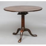 A George III mahogany birdcage tilt top tripod table Of circular form with a turned column,